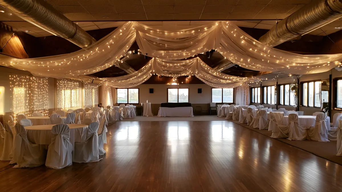 An event hall with white tablecloths and string lights before guests arrive